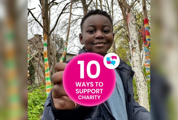 Boy in a wooded area holding pink circle with the Jigsaw4u logo which says 10 ways to support charity