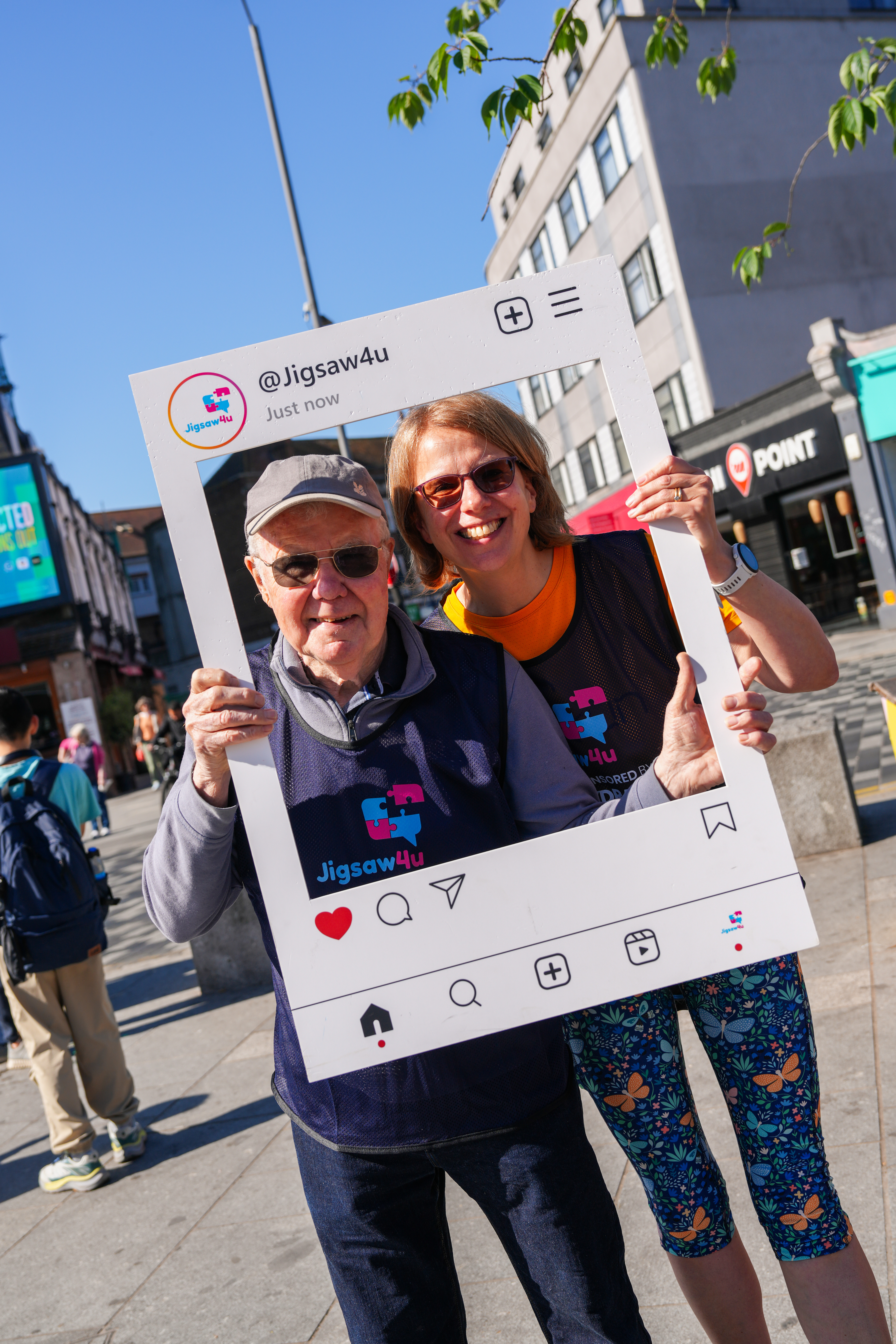 Two walkers holding selfie frame