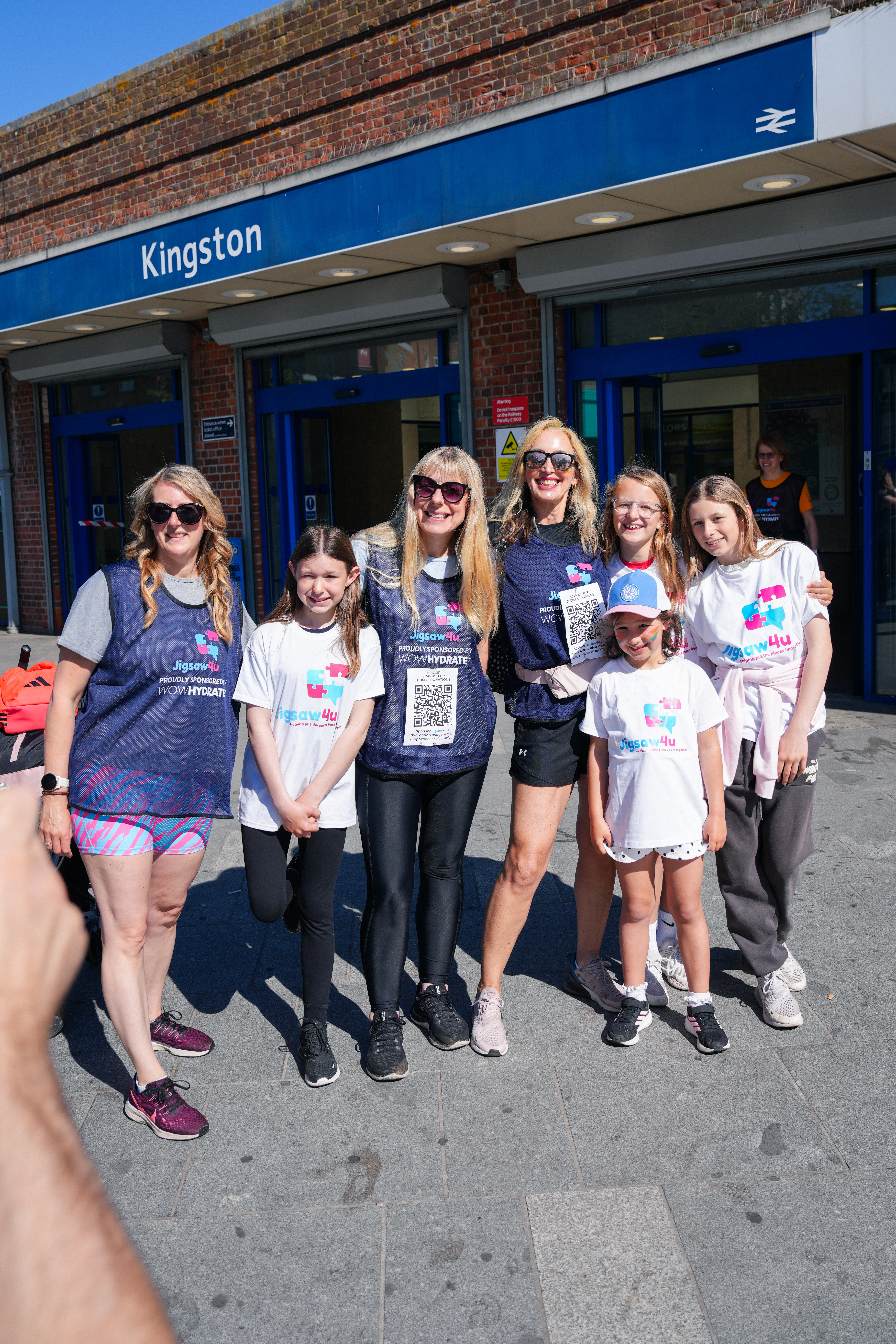 A group of Mums and daughters ready to start the SW London Bridge Walk from Kingston Station. They walked the first leg wearing Jigsaw4u tops and WOW Hydrate sponsored bibs with QR codes on it to donate to the walk.