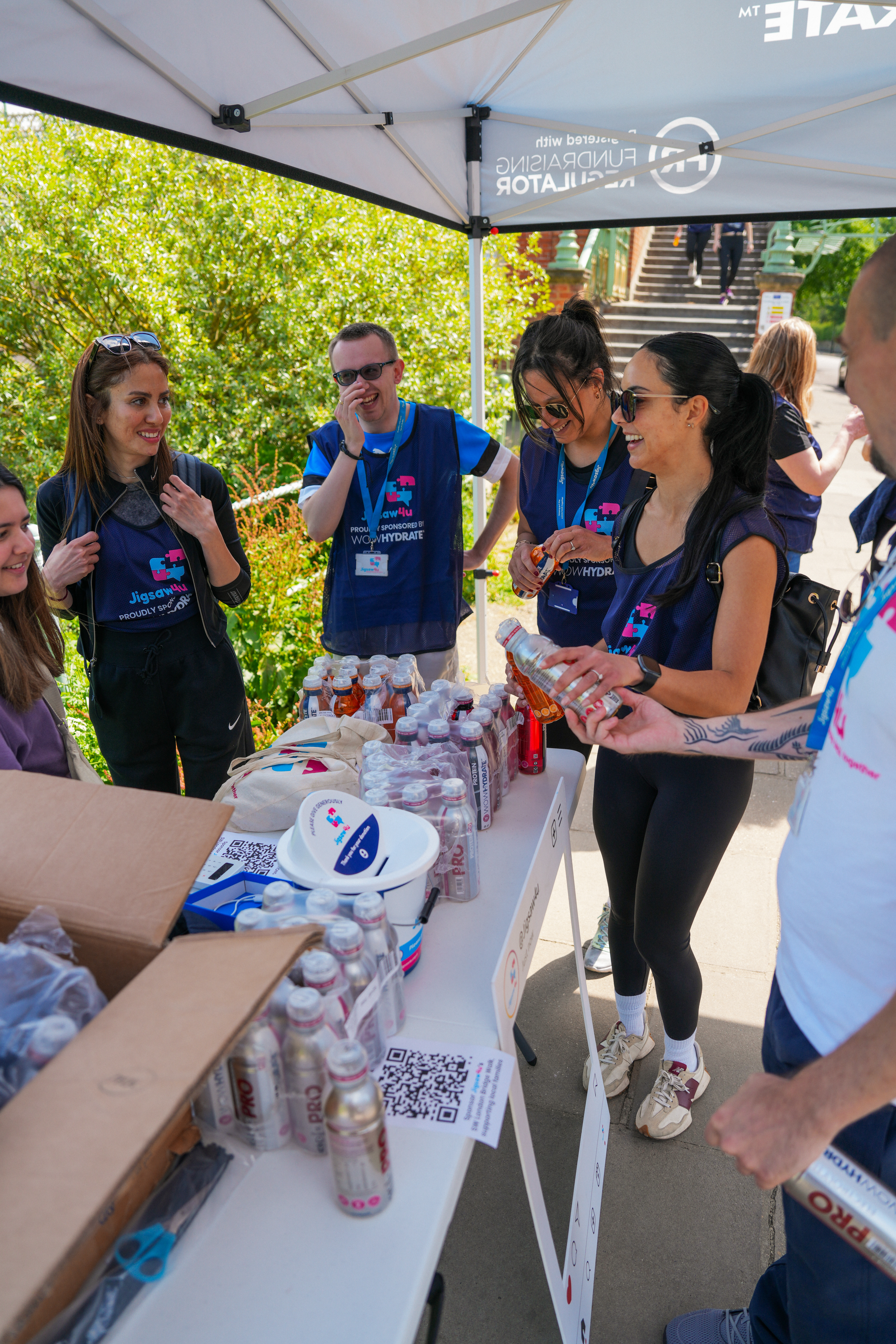 Group of walkers and fundraisers from Jigsaw4u with WOW Hydrate bottles for the SW London Bridge Walk 2024 at the first break stop